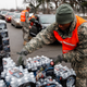 Army National Guard Specialist David Brown loads bottled water into waiting cars at a fire station on Jan. 21, 2016 in Flint, Michigan.